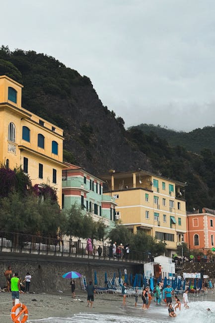 Maisons colorées en bord de plage à Cinque Terre, baigneurs présents