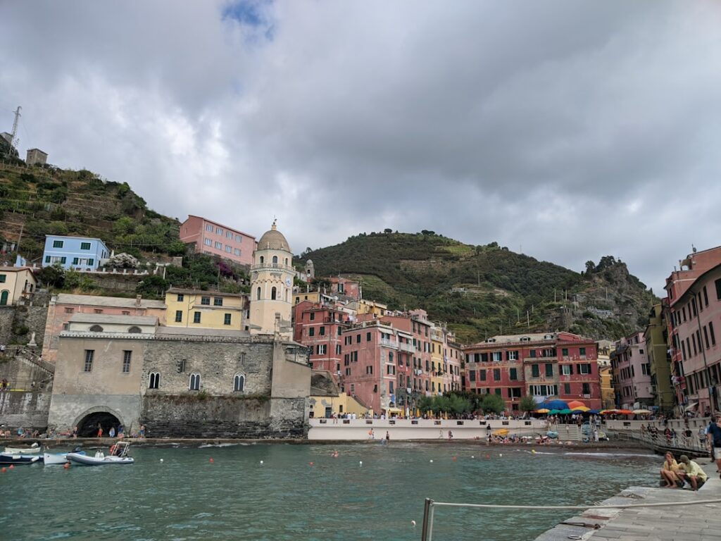 Vernazza Cinque Terre village waterfront with church tower under clouds
