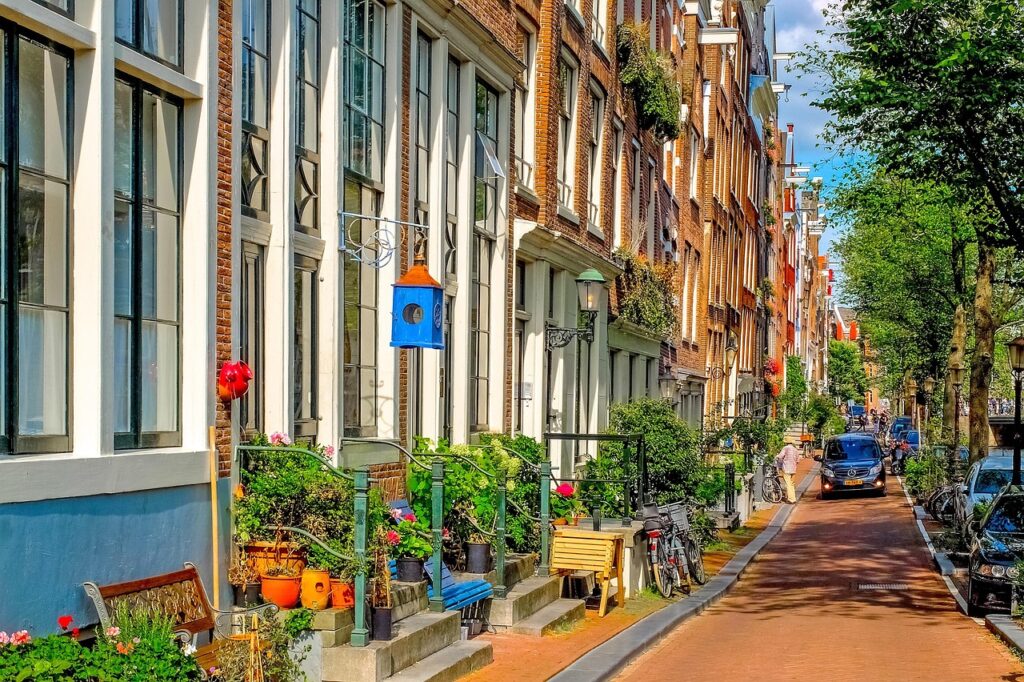 Narrow Jordaan street with cafés in morning sunlight