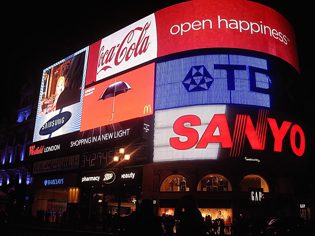 Piccadilly Circus neon signs and evening pedestrians