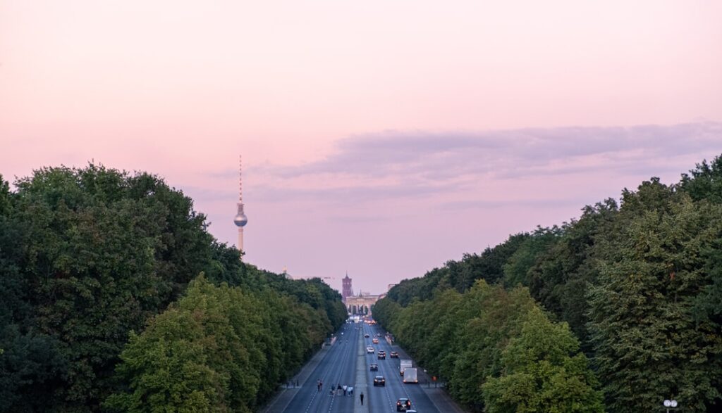 Evening walkway in Tiergarten with lampposts near Brandenburg Gate
