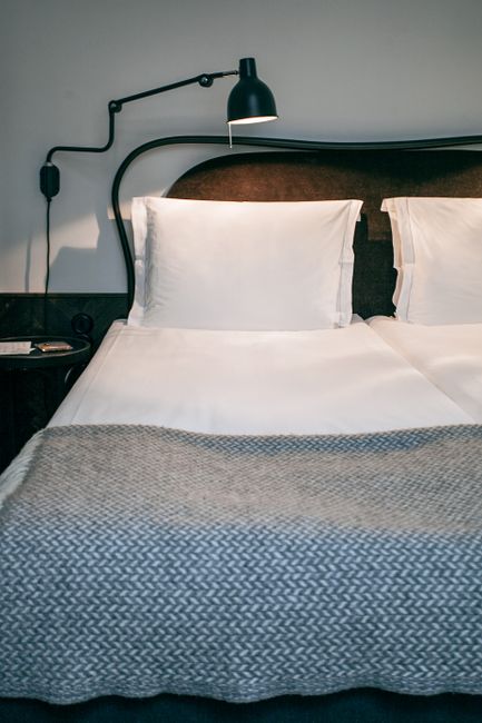 Boutique hotel room in Mitte with stylish bed and lamp