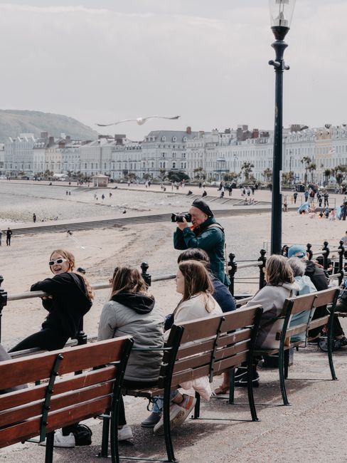 Morning walkers on Portobello promenade with sea and benches