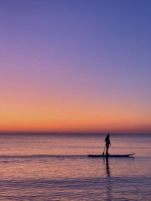 Stand-up paddleboarding at Portobello beach under clear sky