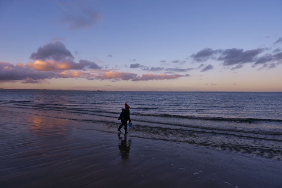 Sunset walk on Portobello beach with silhouetted people