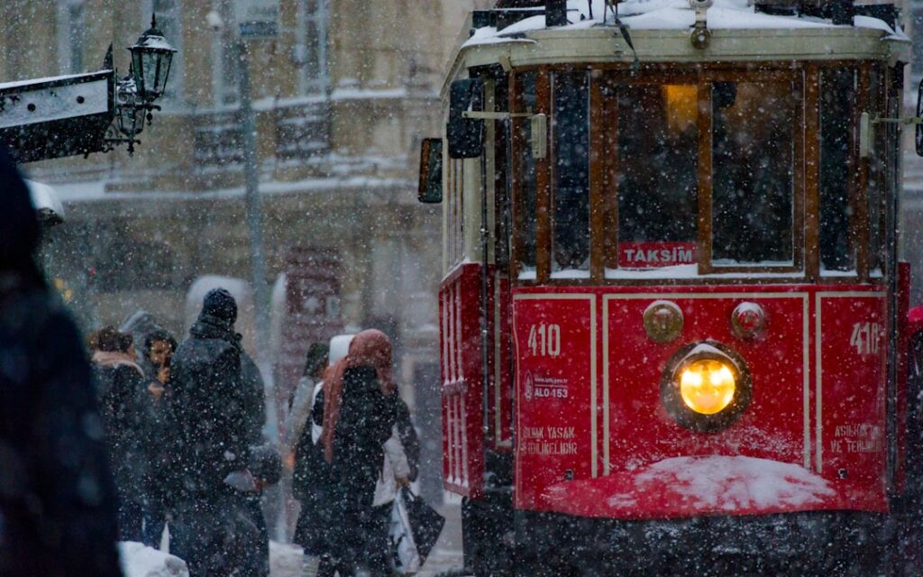 Istiklal Street tram on a rainy evening with lights