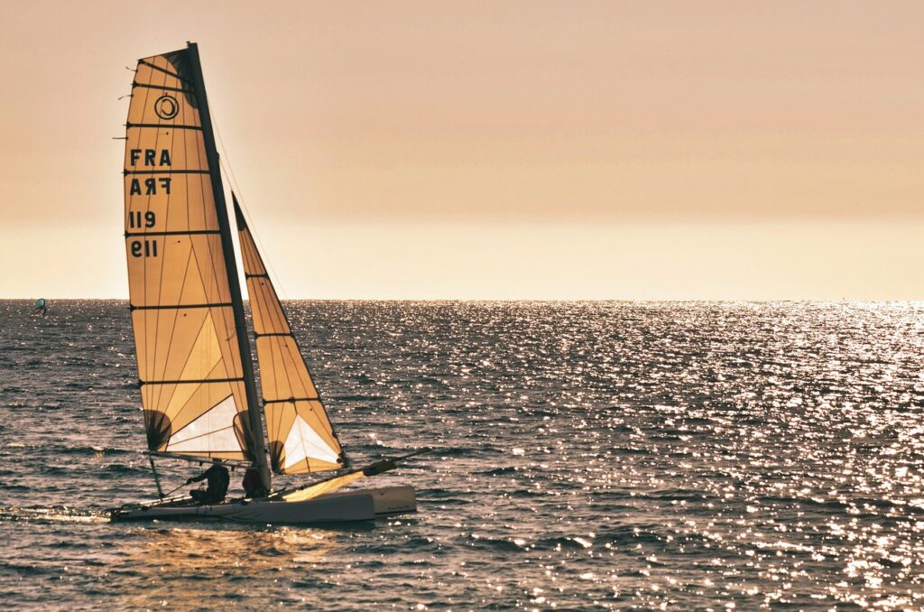 Paloma beach at sunset with sailboats in Saint-Jean-Cap-Ferrat