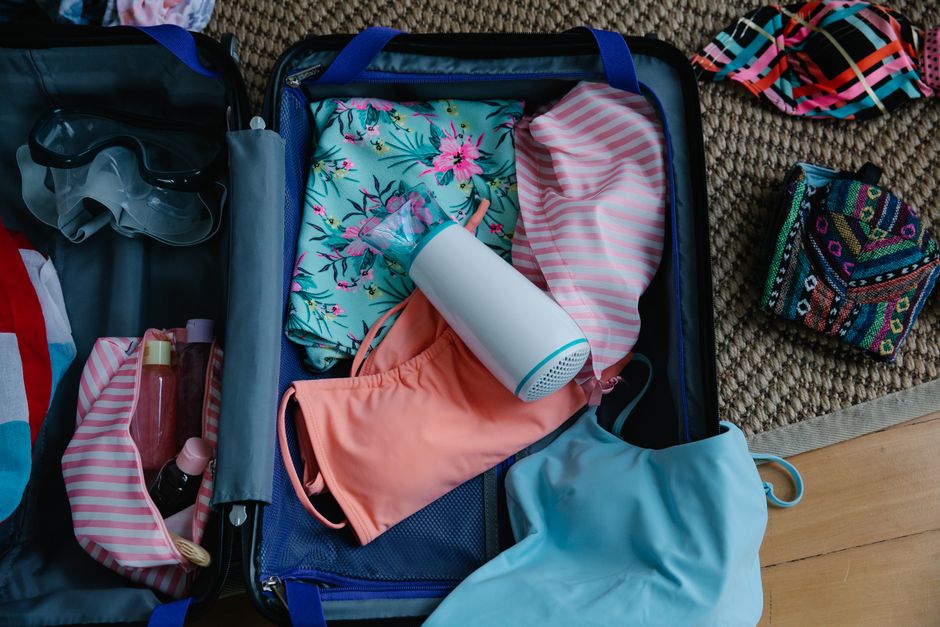 Traveler packing beach essentials for a coastal day trip near Nice