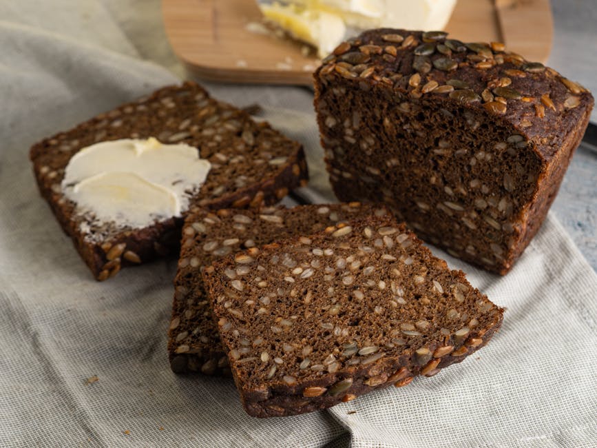 Close-up of hands holding rye bread with Danish vocabulary notes