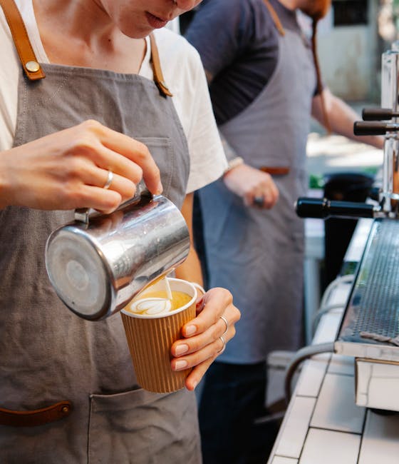 Barista pouring espresso at The Coffee Collective in Torvehallerne market