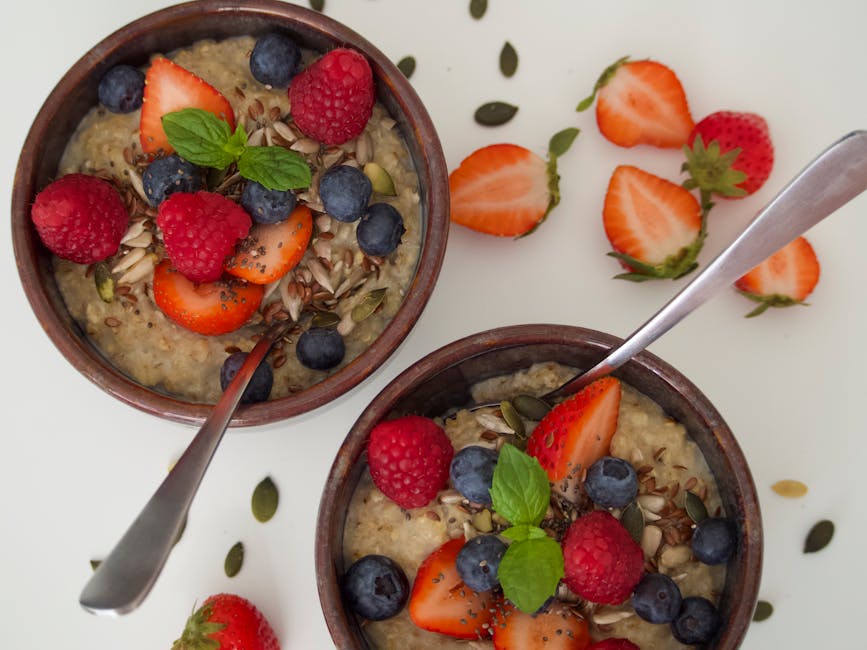 Porridge bowl topped with berries and seeds at Grød