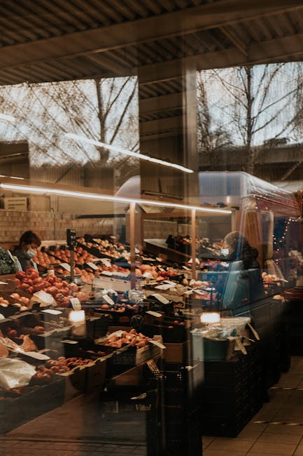 Glass market stalls at Torvehallerne with people shopping fresh produce