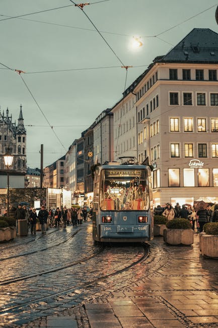 Munich tram crossing a historic street lined with cafes
