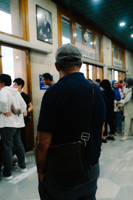Queue at municipal office with people waiting