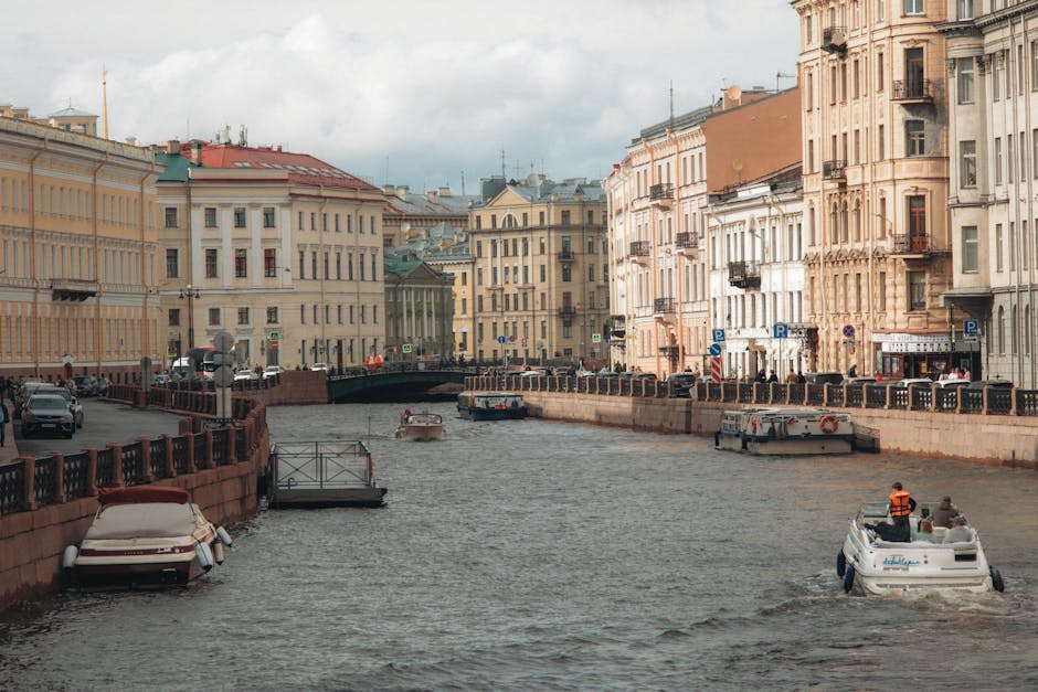 Saint Petersburg canal with summer boats near historic buildings