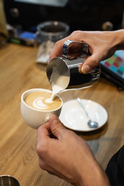 Barista preparing a flat white in a cosy Emmet Road coffee shop