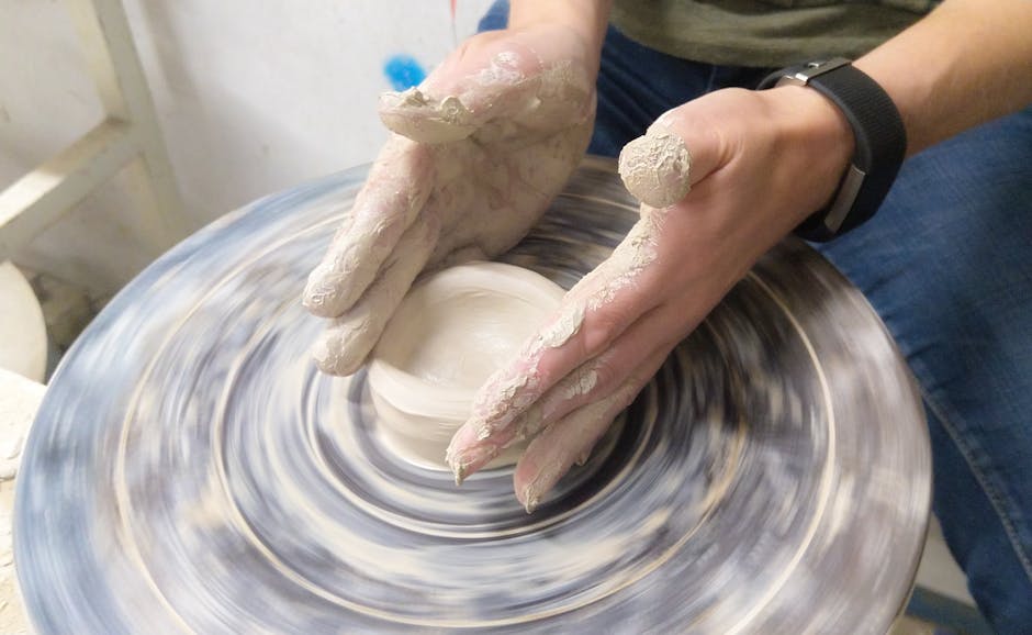 Hands shaping clay on a pottery wheel in Inchicore