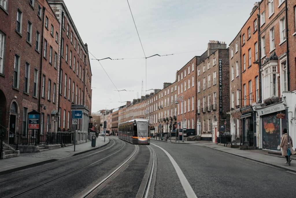 Dublin street with LUAS tram and passengers, city transport scene