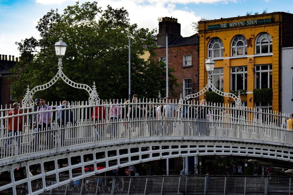Ha'penny Bridge mit Fußgängern und Radfahrern bei Sonnenuntergang