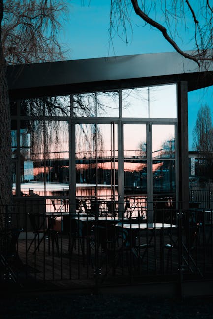 Interior of The Woollen Mills café with river views and wooden chairs