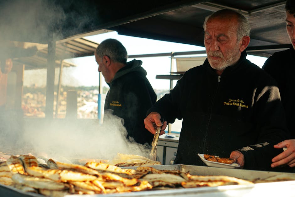 El Tintero servers offering grilled fish beachside