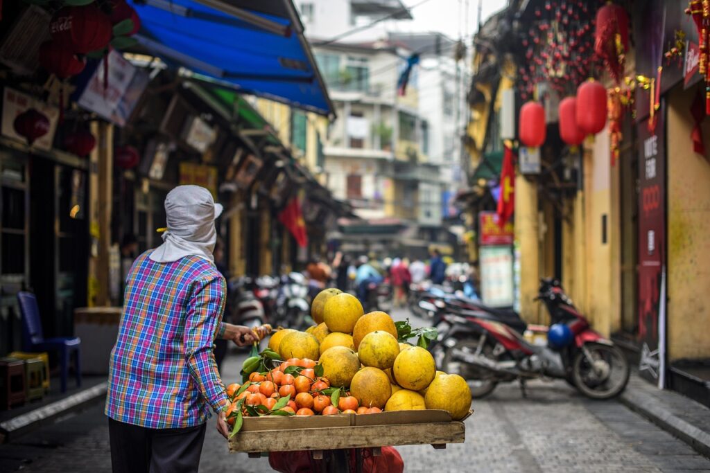Busy street market with shoppers and stalls