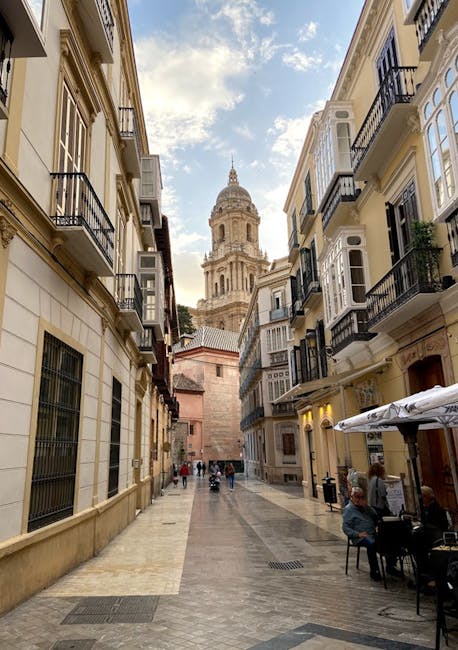 Historic street in Malaga with morning light and cathedral view