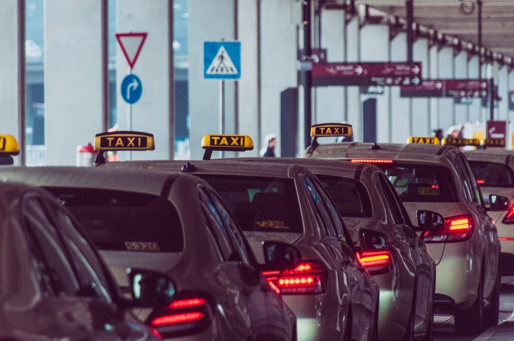 Taxi queue at Málaga airport arrivals exit with city background