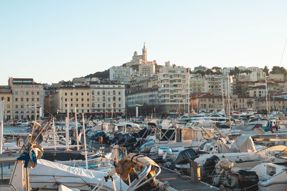 Sunset over Marseille's Vieux-Port with boats and city skyline