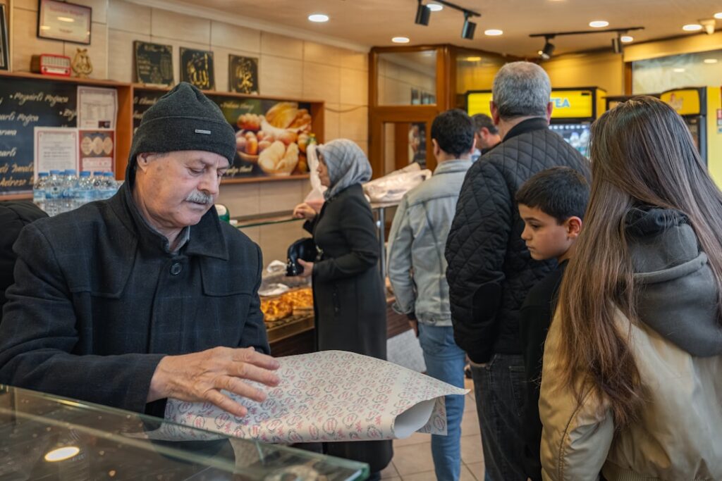 Customers buying fresh cannelés at Baillardran