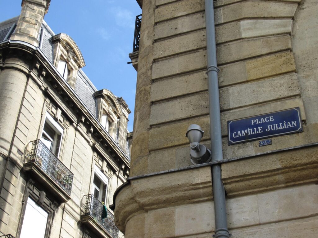 traveler enjoying a cannelé at Place Camille Jullian in Bordeaux