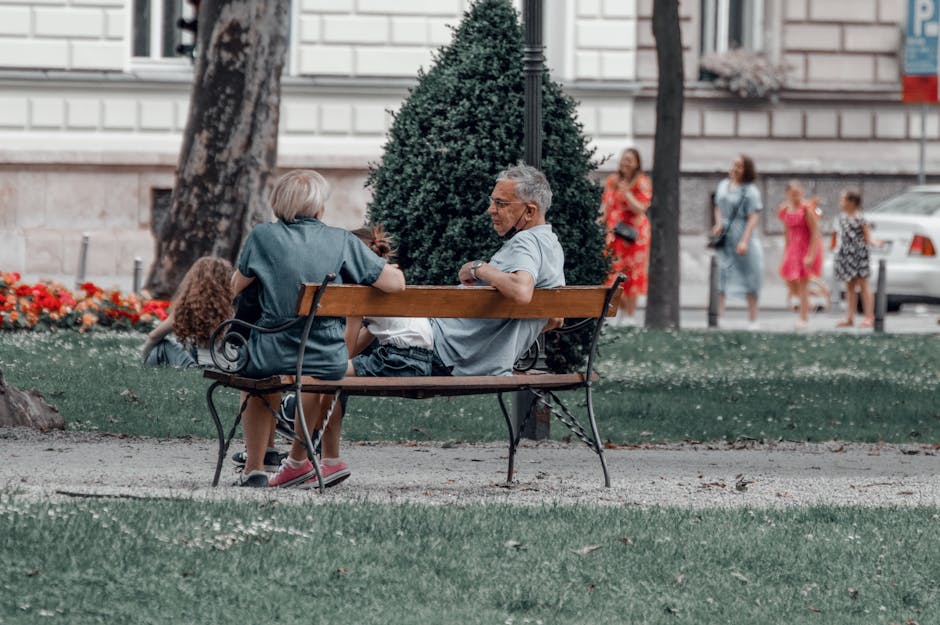 People relaxing in Esplanadi Park on wooden benches during a summer concert