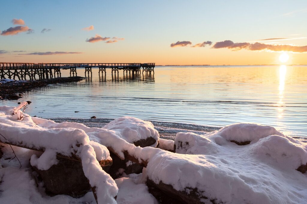 Sunrise on Helsinki waterfront with person on pier