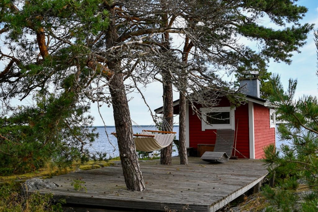 Löyly sauna wooden terrace with sea view at sunset
