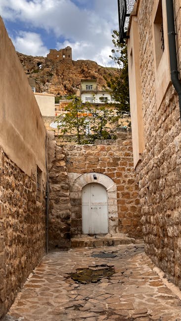 Narrow morning street in Corte with citadel view