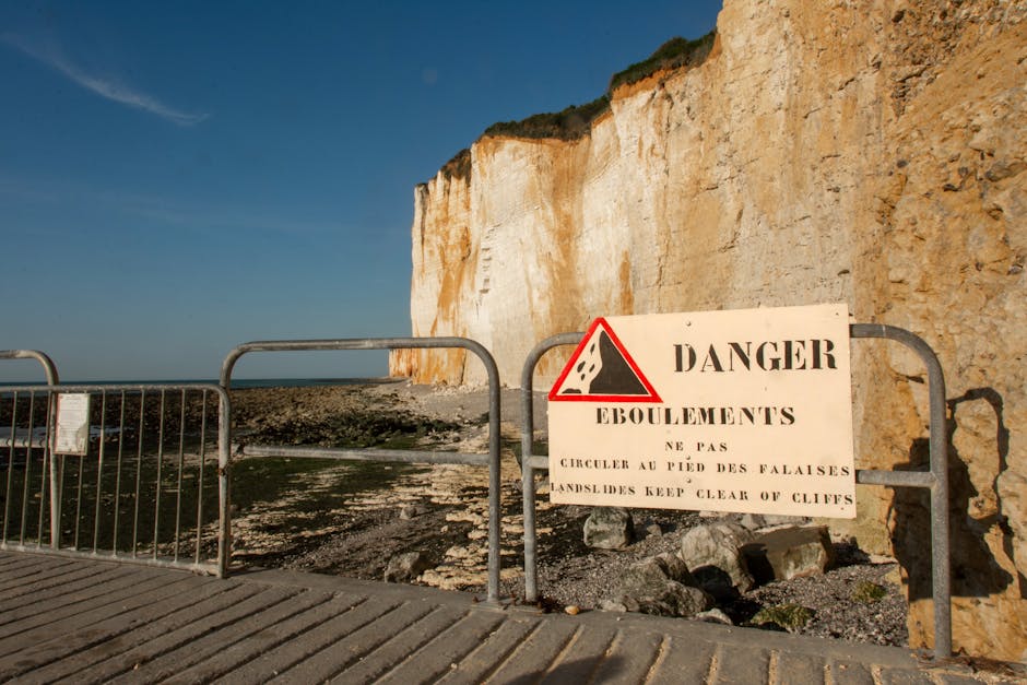 Warning sign about cliff erosion on Corsican coast