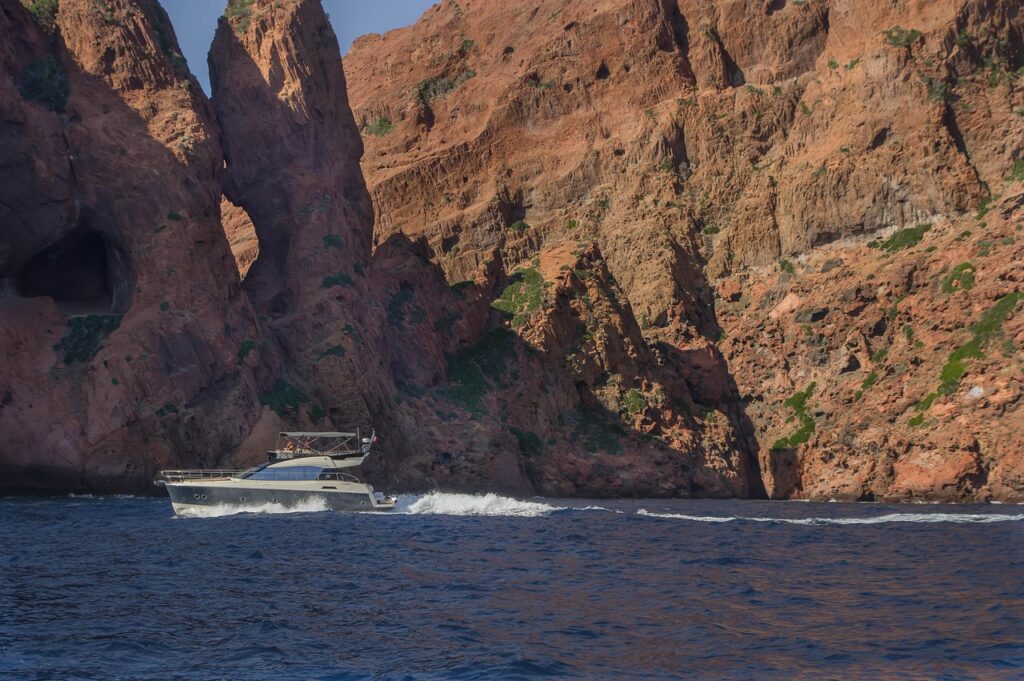 Boat view of the red cliffs in the Scandola Reserve