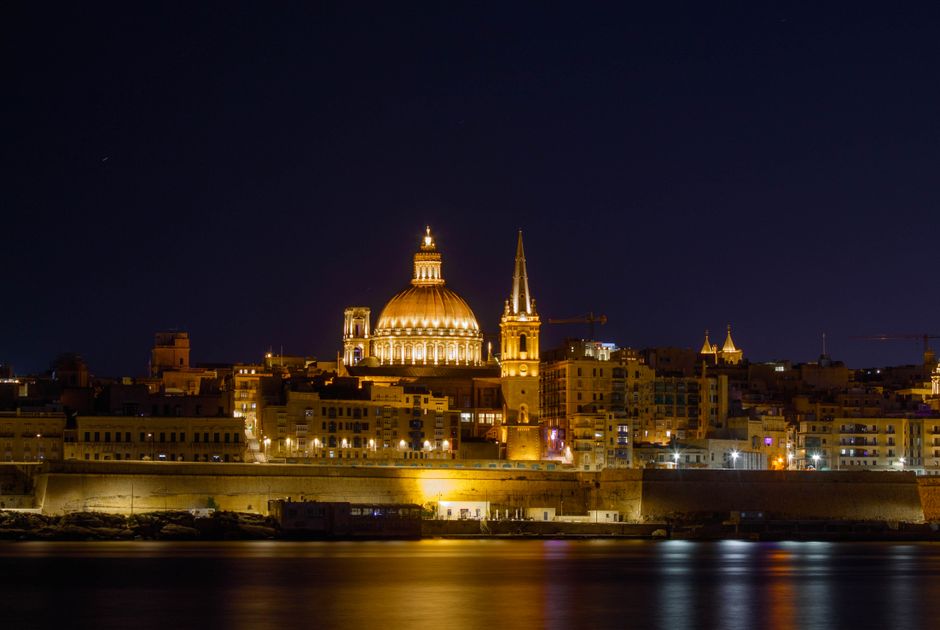 View of Valletta bastion at night with illuminated dining area