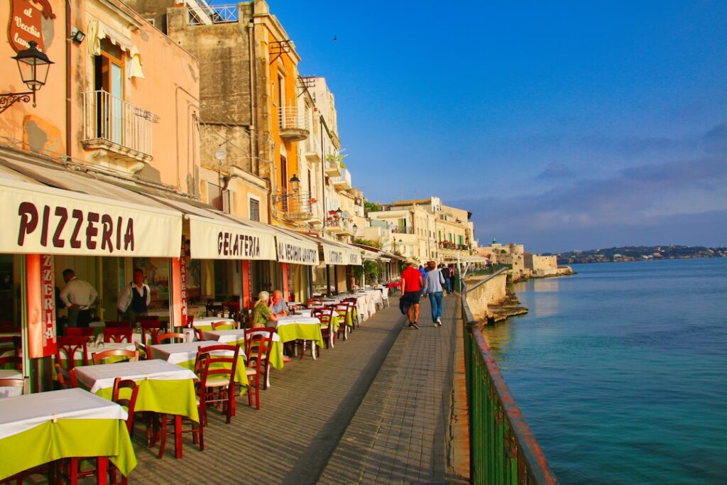 Valletta sunset harbour view with diners at outdoor restaurants