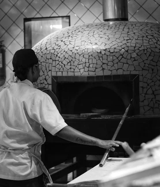 Chef sliding pizza into tiled wood-fired oven in Naples pizzeria