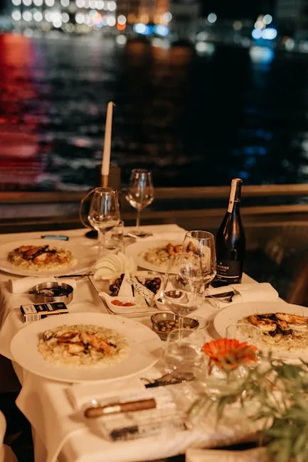 Seaside dinner table in Procida with wine, plates, and candlelight