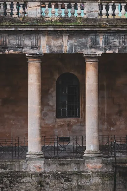Weathered stone columns and balustrade of Naples Roman baths