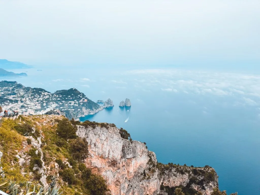 Clifftop view of Capri coastline with Faraglioni rocks and sea