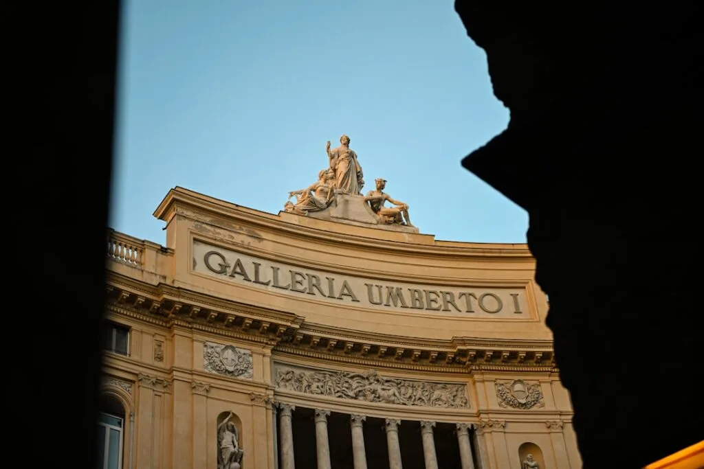 Galleria Umberto I facade in Naples framed by a dark archway