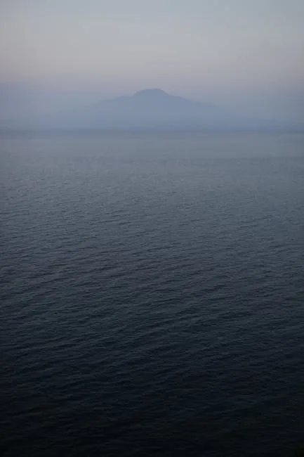 Calm twilight sea with distant Mount Vesuvius silhouette near Naples