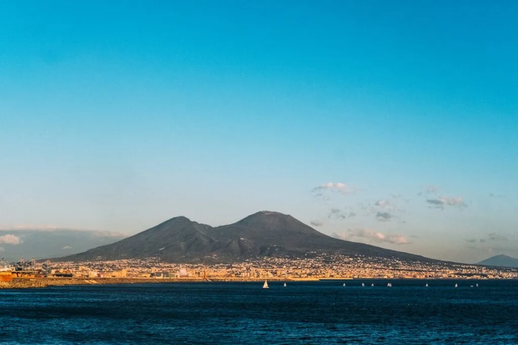 Mount Vesuvius towering over the Bay of Naples with sailboats