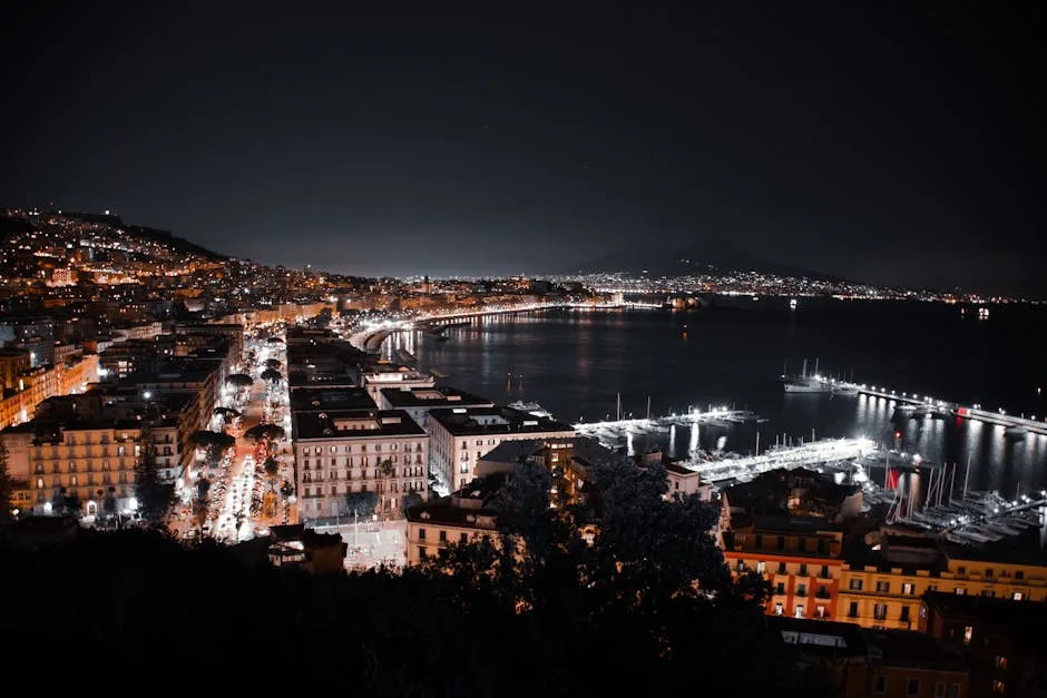 Night panorama of Naples waterfront and Mount Vesuvius across the bay