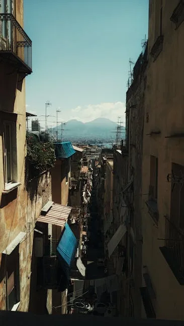View down a steep Naples street in the Spanish Quarter toward Vesuvius