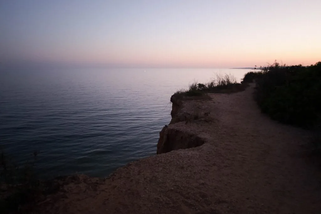 Narrow cliffside path above the Tyrrhenian Sea near Naples at dusk
