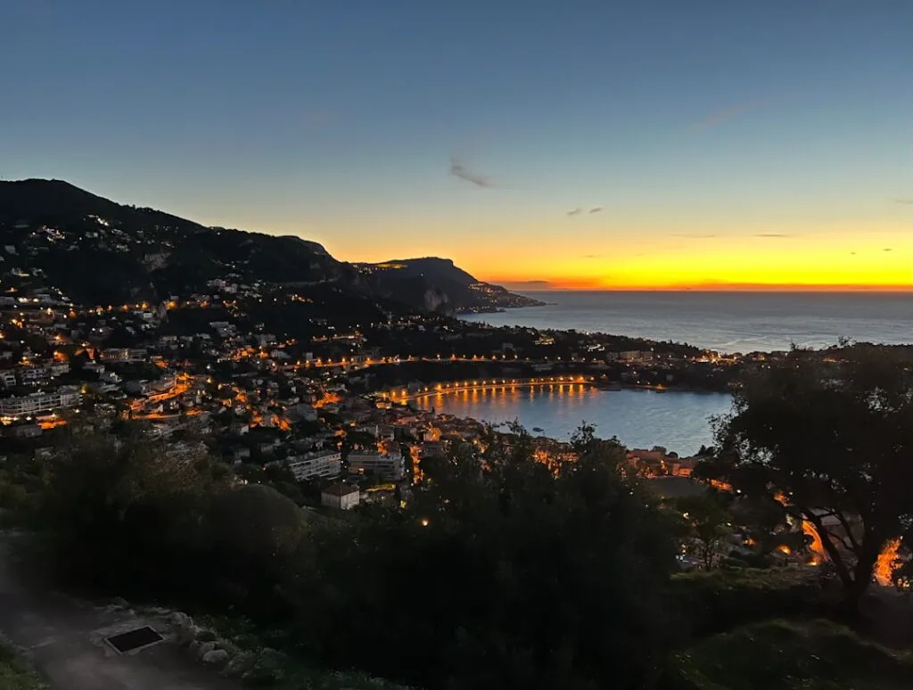 Hilltop view of coastal town and illuminated bay near Naples